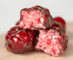 Delicious Cherry Mash Candy with rich cherry flavor and creamy chocolate coating on a rustic background