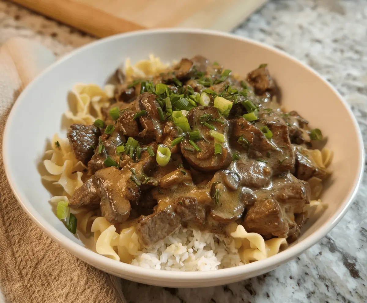 Delicious gluten-free beef stroganoff served over creamy mashed potatoes.