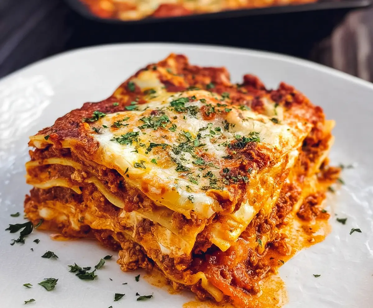 Delicious homemade lasagna layered with rich meat sauce and melted cheese, labeled as the world's best recipe.