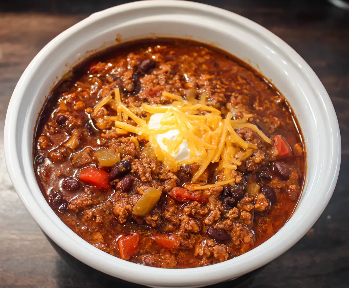 Delicious crockpot root beer chili served in a bowl with fresh toppings