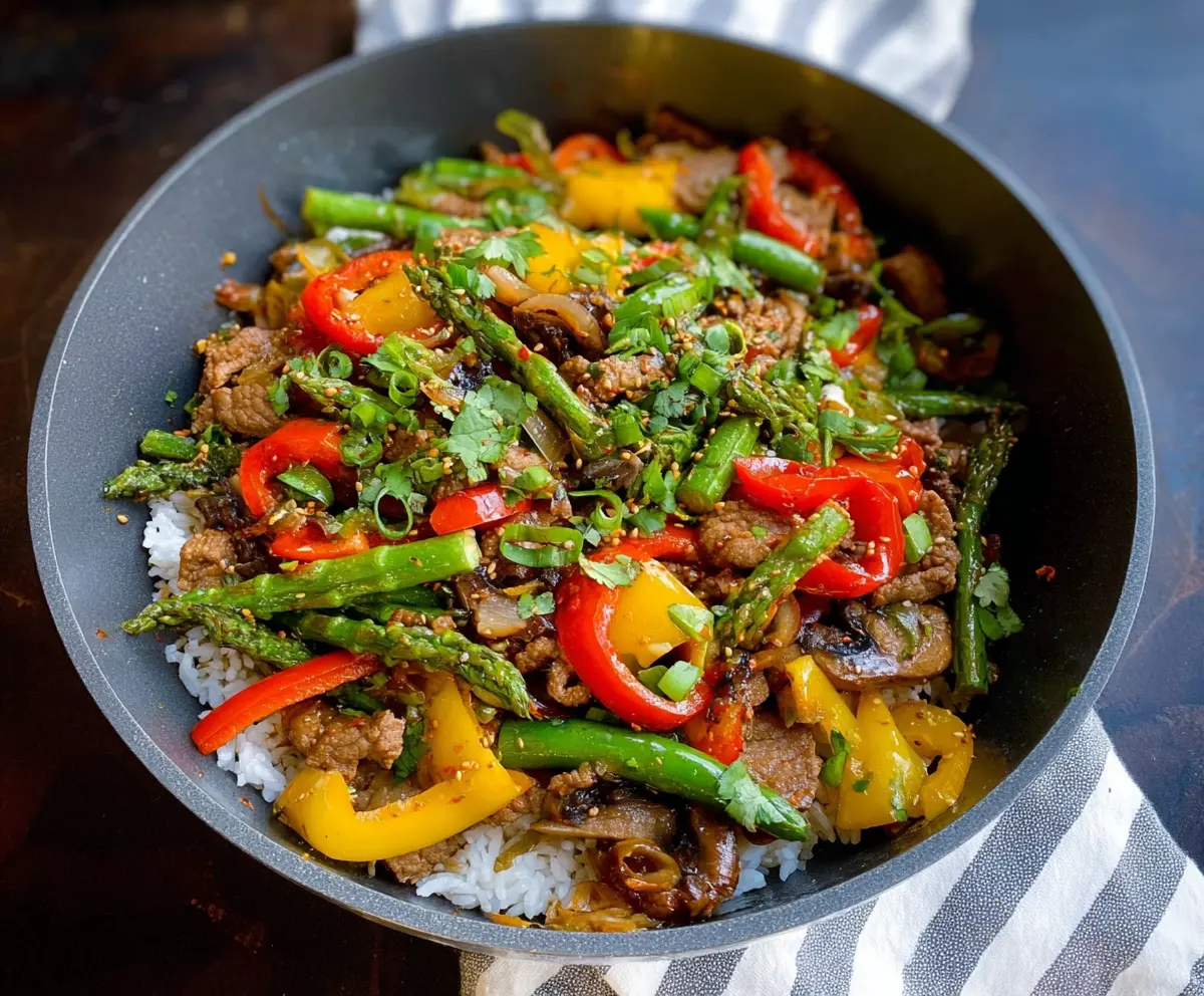 Delicious garlic pork stir-fry served with fresh vegetables on a white plate