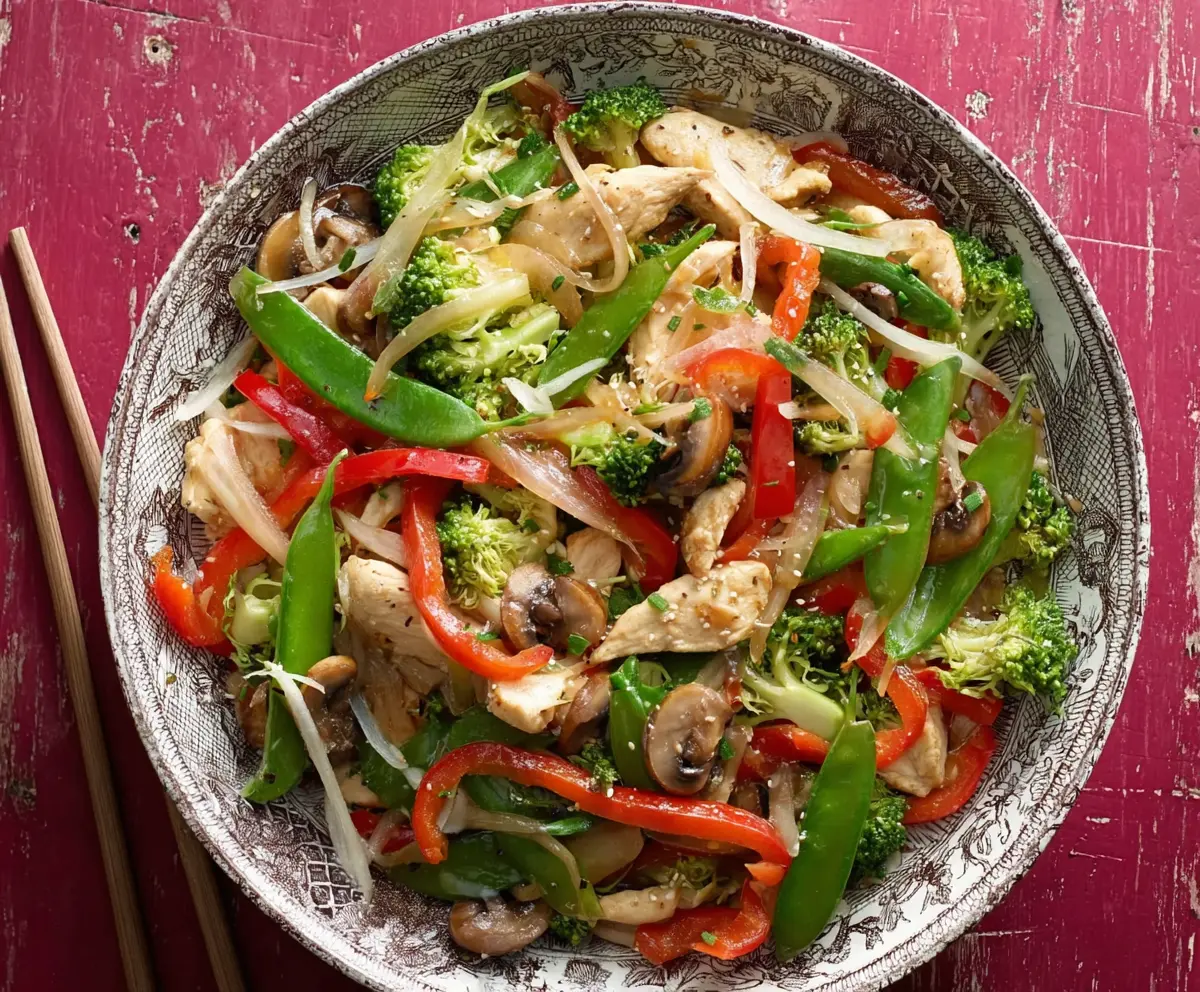 Delicious garlic chicken stir fry with fresh vegetables and savory sauce ready to serve.