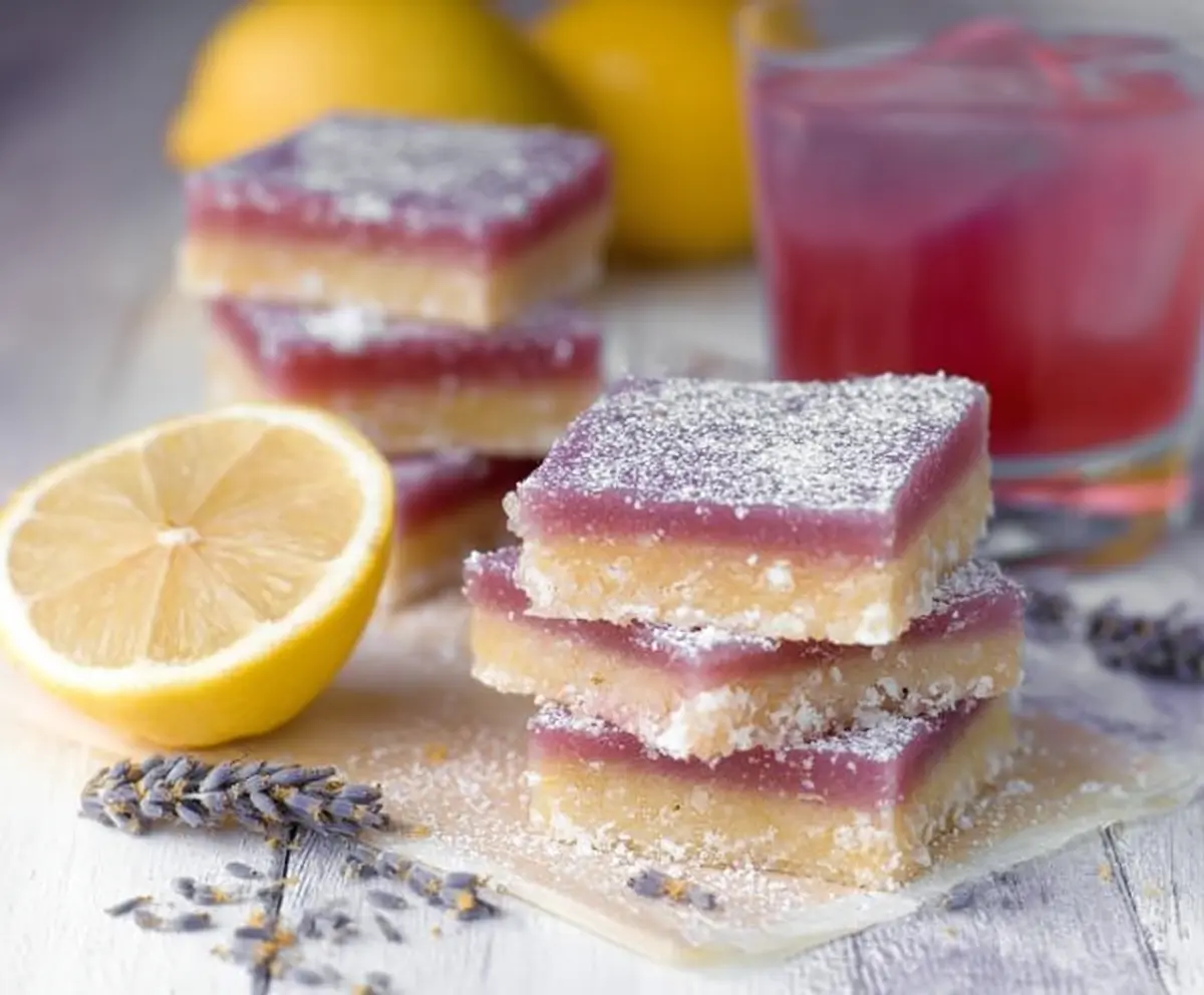 Delicious lavender lemon bars on a decorative plate showing a vibrant citrus dessert with lavender garnish.