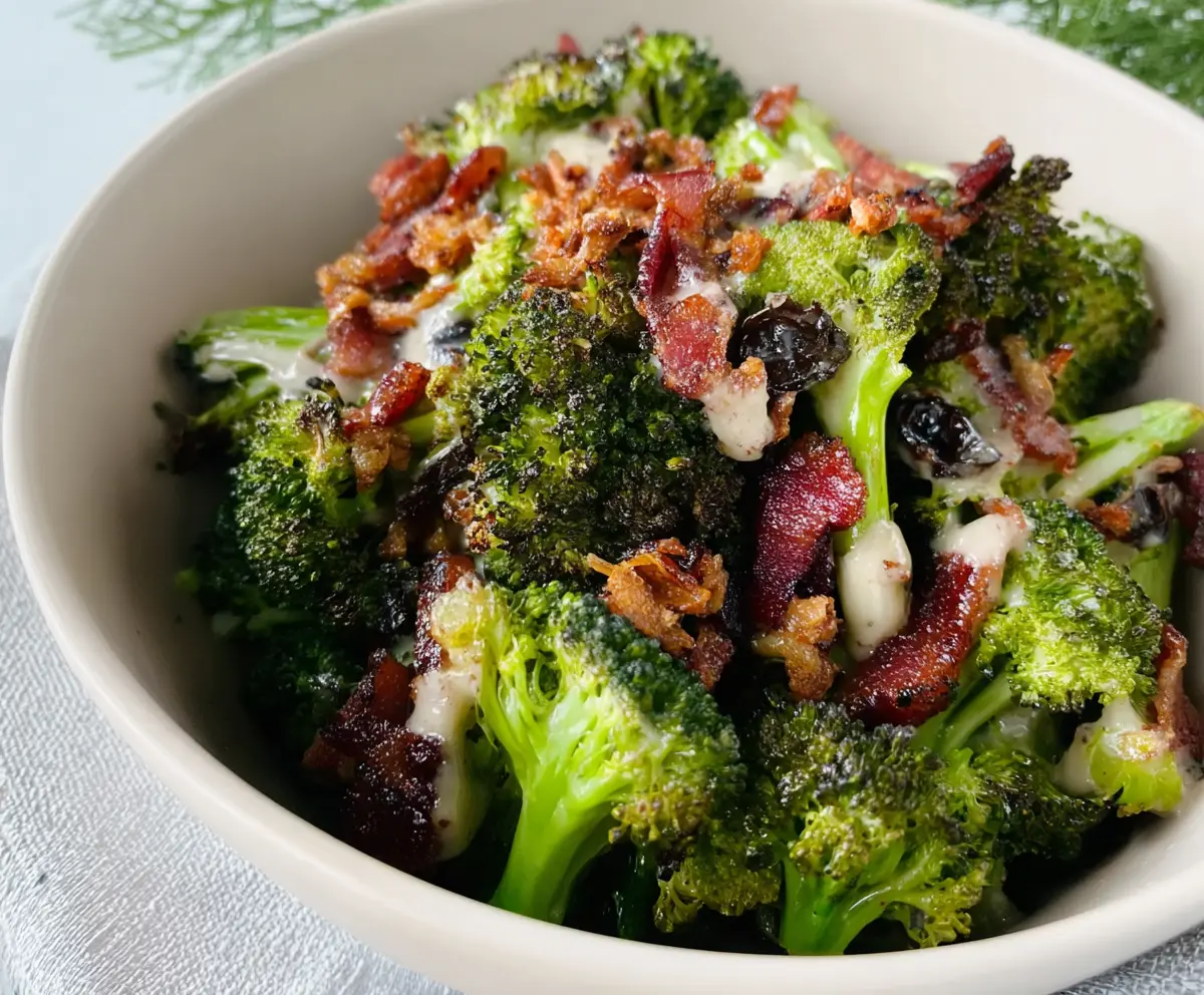 Delicious roasted broccoli bacon crunch salad with fresh greens and crispy bacon bits.